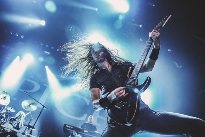Mark Jansen, the lead guitarist for the metal band Epica in a blue-lit concert.
