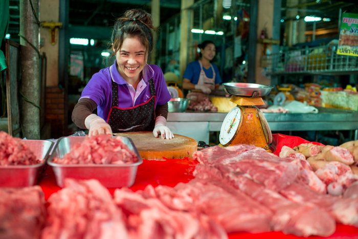 Lady in a market selling meat