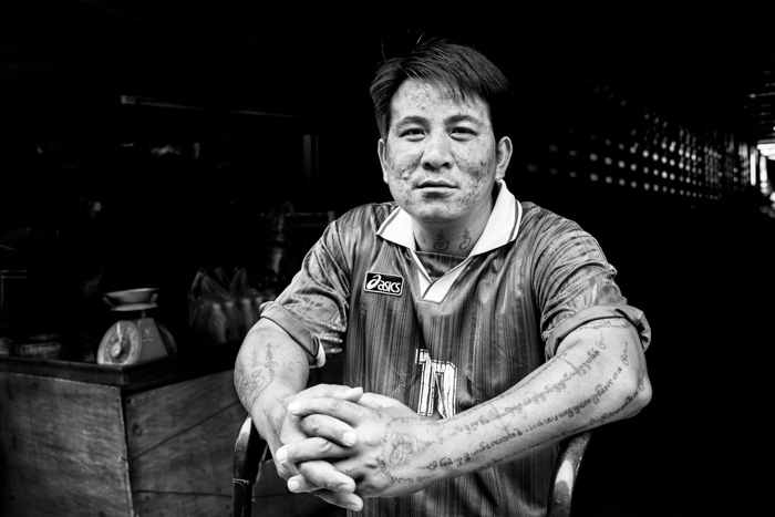 Black and white documentary photography of a portrait at a market in Chiang Mai, Thailand