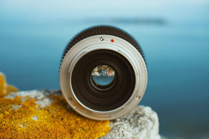 Image of a wide angle lens resting on a rock