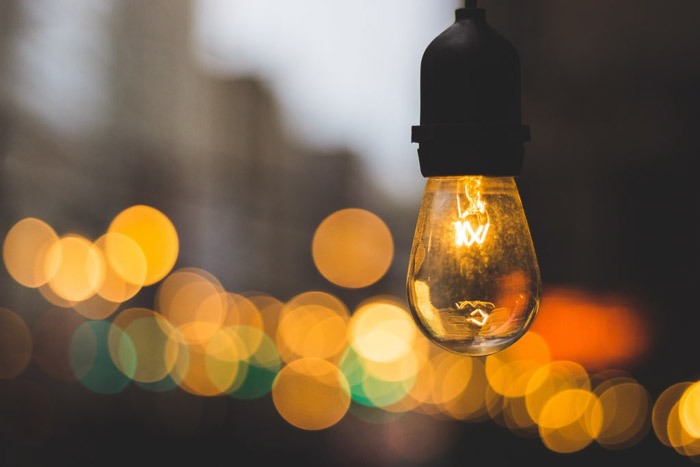 A lightbulb in the foreground of blurry bokeh lights