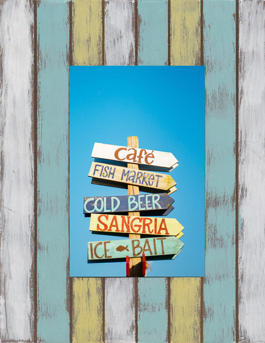 A wooden beach cafe sign, framed with a similar wooden pattern in Photoshop