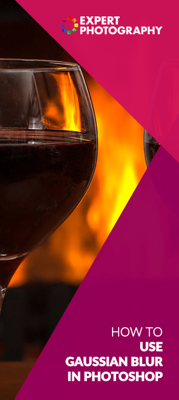A photo of a bottle of wine and two glasses with a fire in the background, the result of using gaussian blur in photoshop 