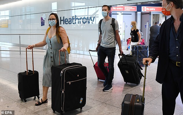 Passengers arrive at Heathrow Airport in London, as it