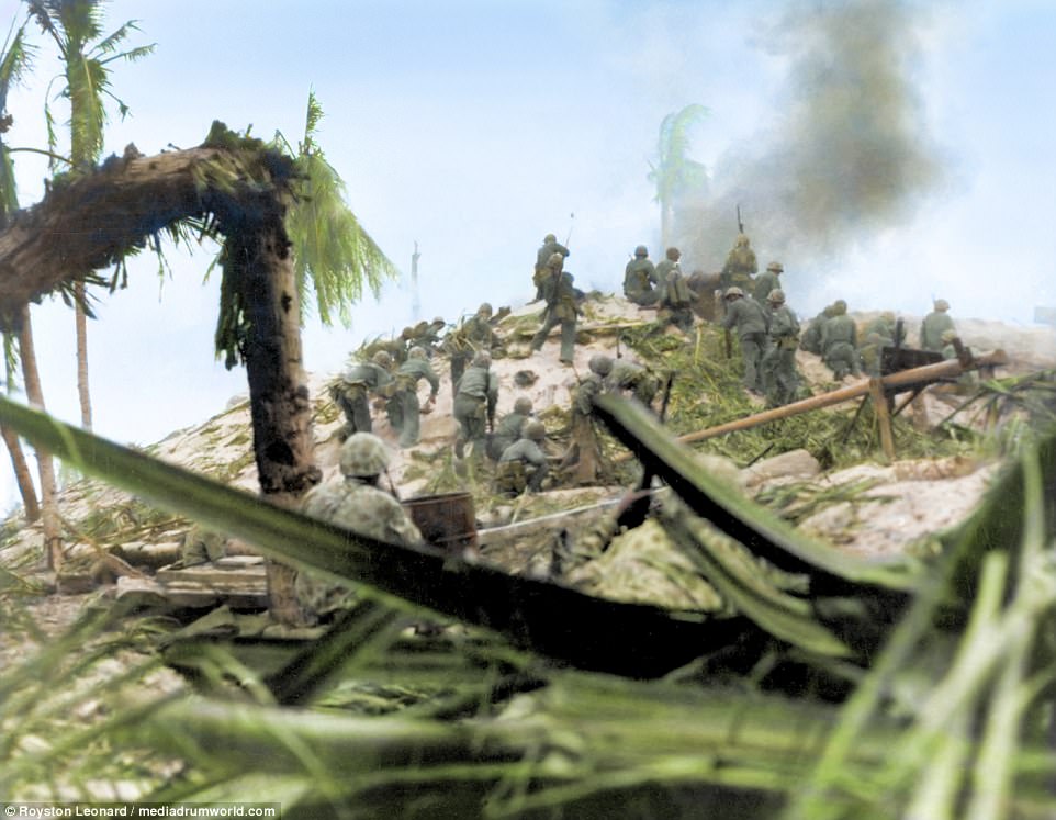 US Marine Corps assault party storm a Japanese stronghold on top of a mound. Japanese forces fought until the last man, with just one officer and 16 troops of the 3,500 plus enlisted men surrendering