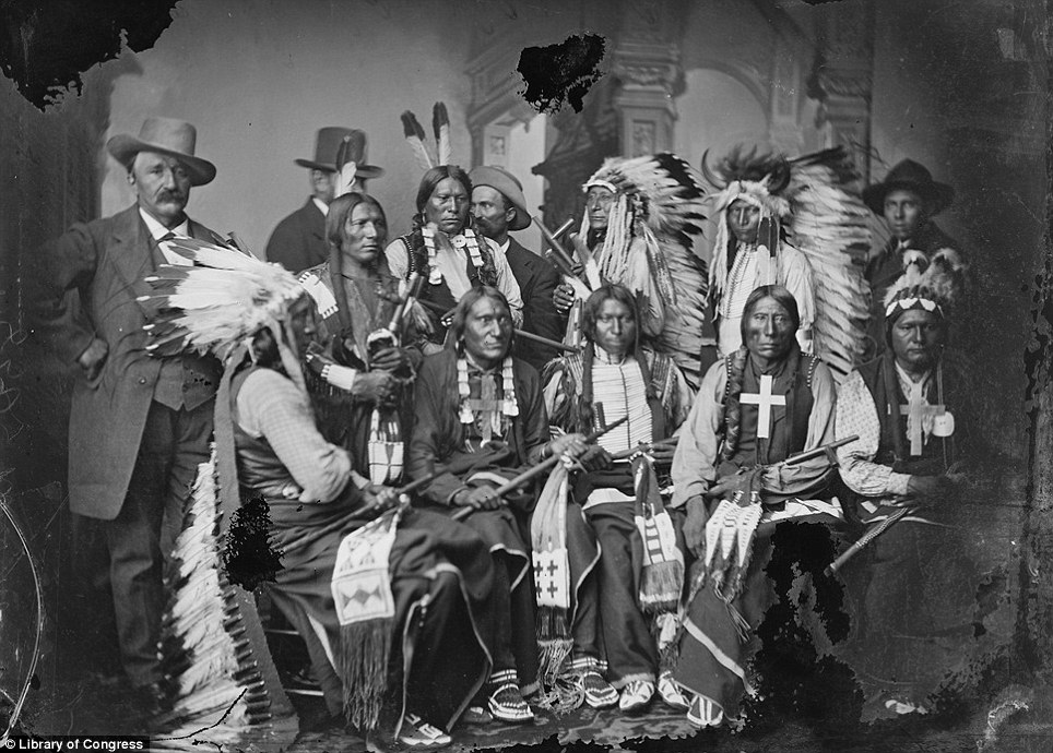 A delegation of visiting Sioux and Arapaho, including Red Cloud, seated at left, and Little Big Man, standing at Red Cloud