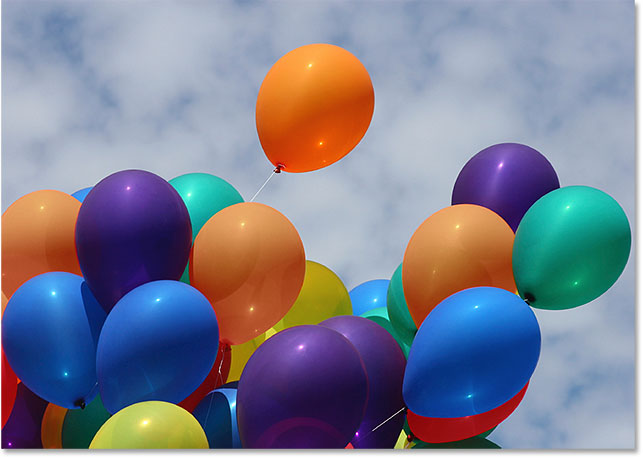 The balloons after reducing their color saturation. Image © 2016 Photoshop Essentials.com
